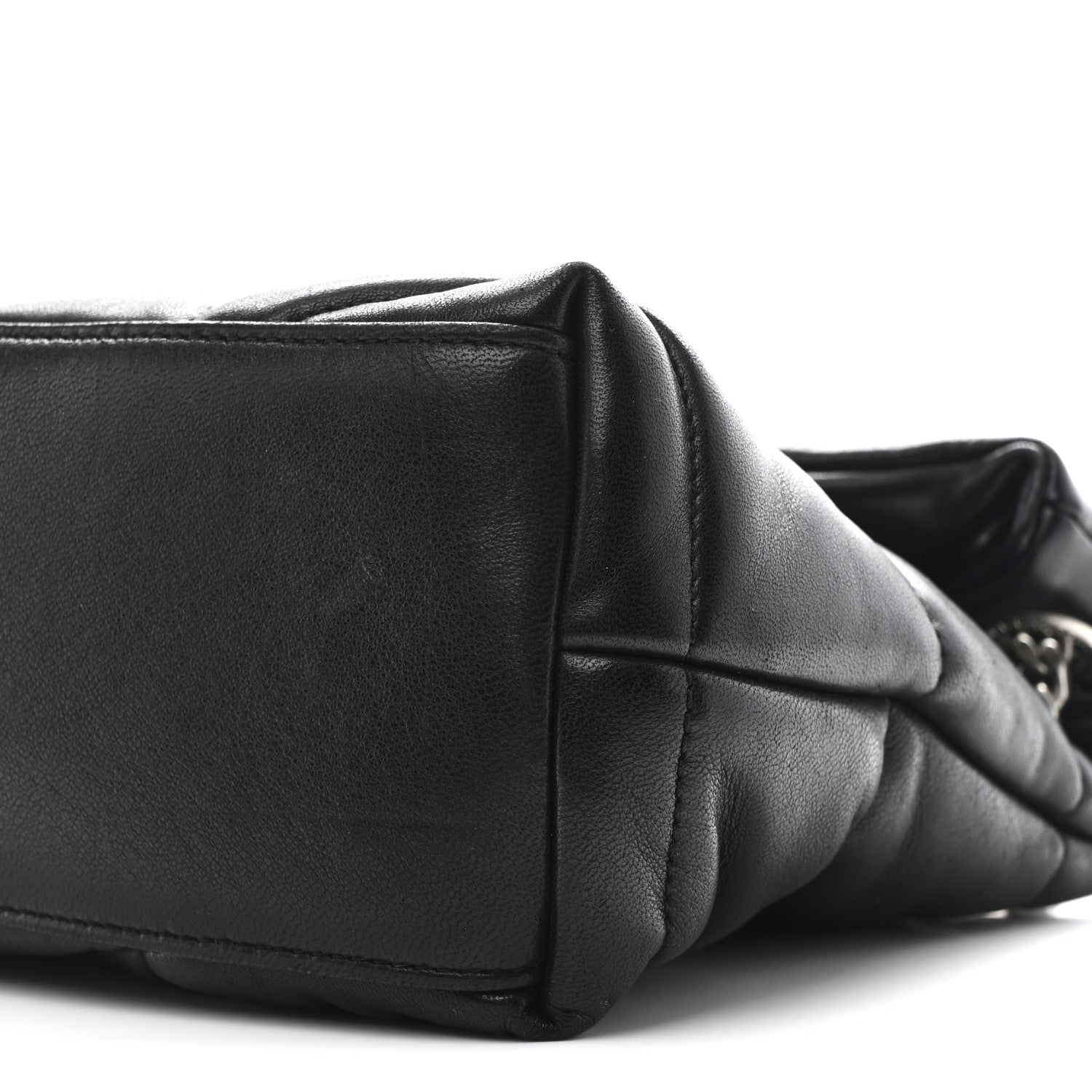 Black quilted lambskin puffer small satchel with flap seam and compact rectangular shape.