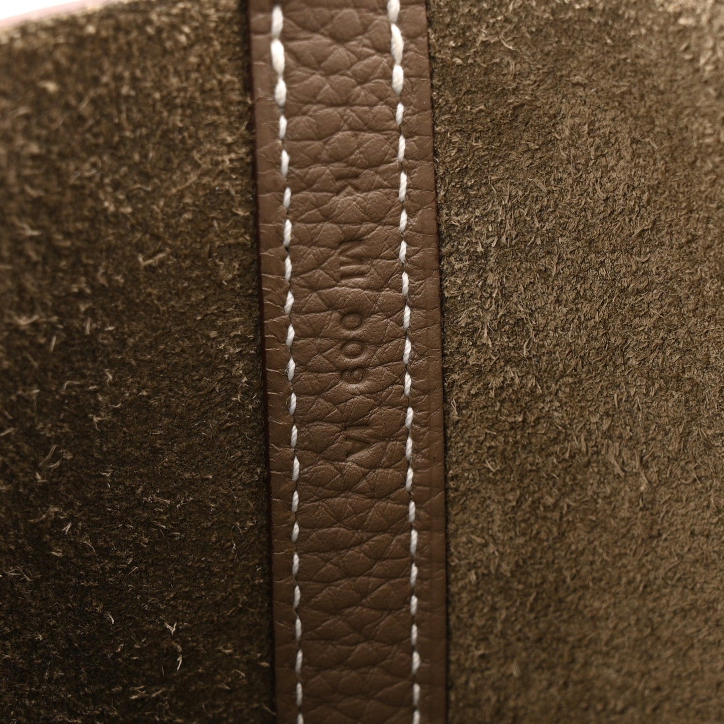 Etoupe leather seam detail with contrast white stitching