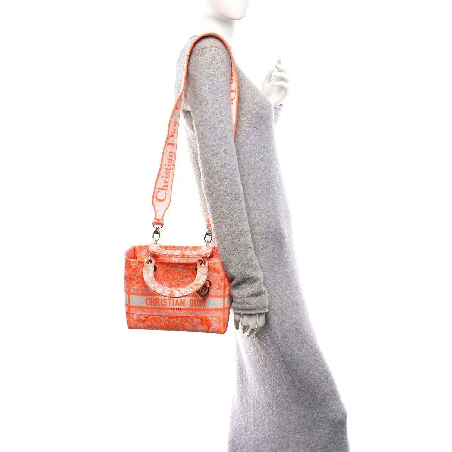 Orange mini Dior embroidered bag with crossbody strap and silver-tone hardware.