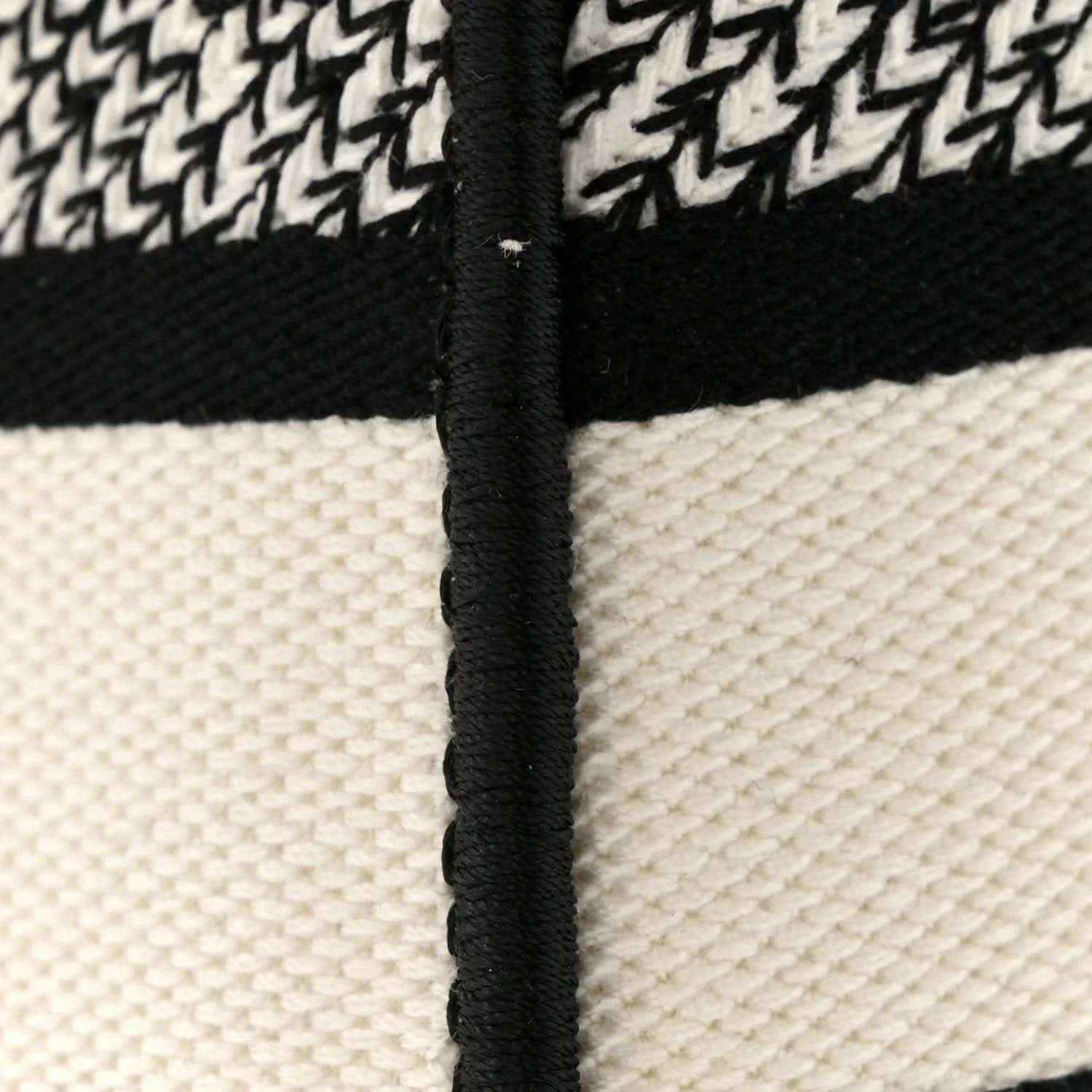Canvas handbag with black trim and vertical zipper edge detail