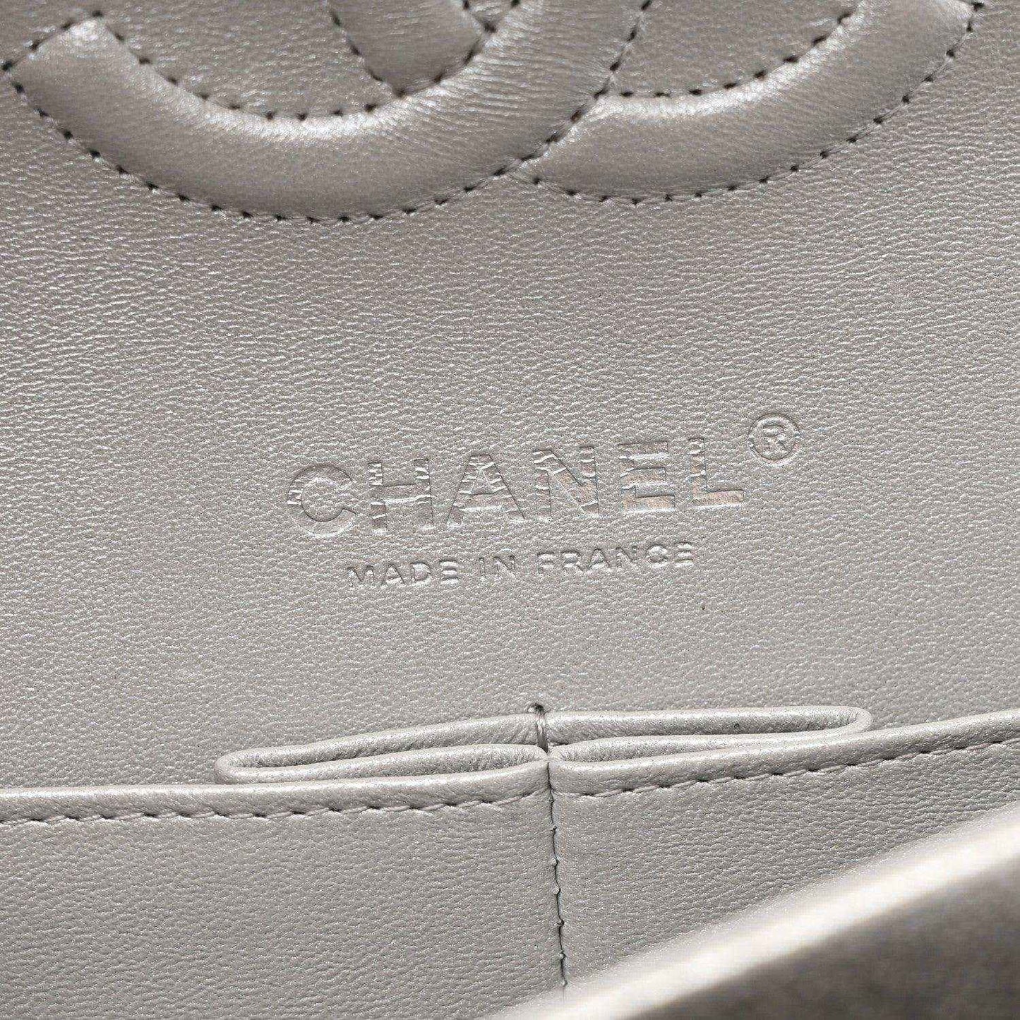Chanel stamped leather panel close-up on silver metallic double flap bag