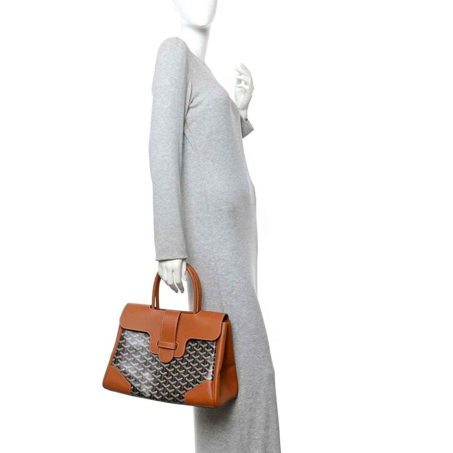 Goyard Saigon tote handbag worn over shoulder, tan handles and monogram canvas