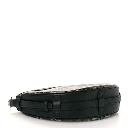 Black crossbody handbag with adjustable strap and front buckle detail