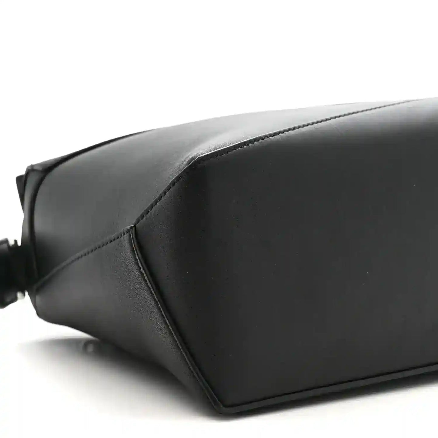 Small Puzzle Edge shoulder bag in black leather with smooth panels and stitched seams