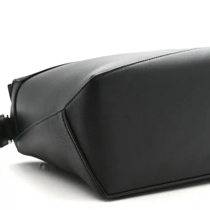Small Puzzle Edge shoulder bag in black leather with smooth panels and stitched seams