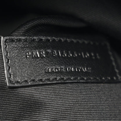 Black leather label with embossed branding and serial text on inner panel