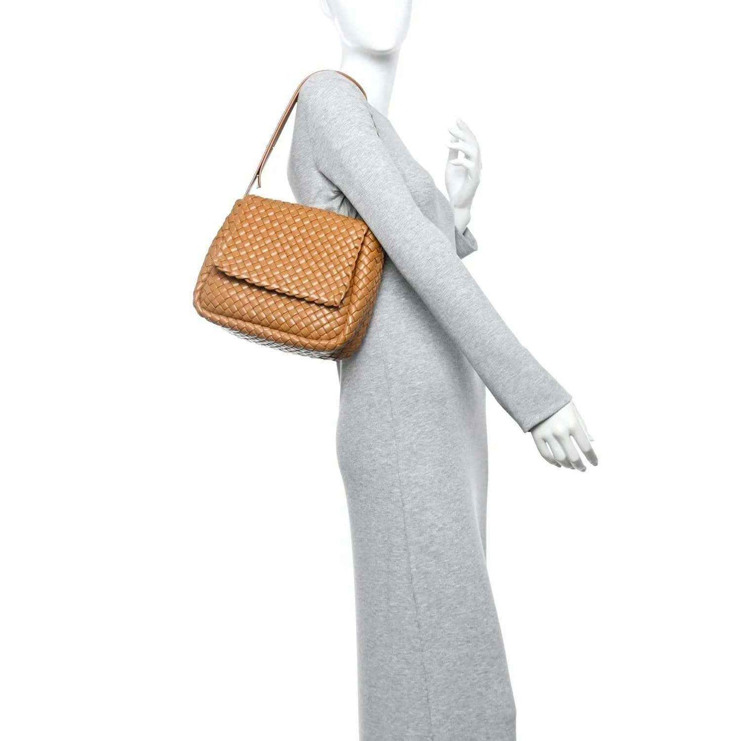 Caramel woven leather shoulder bag on model, small padded intreccio design with top handle