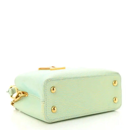 Mini Capucines handbag in light green textured leather with gold feet and hardware
