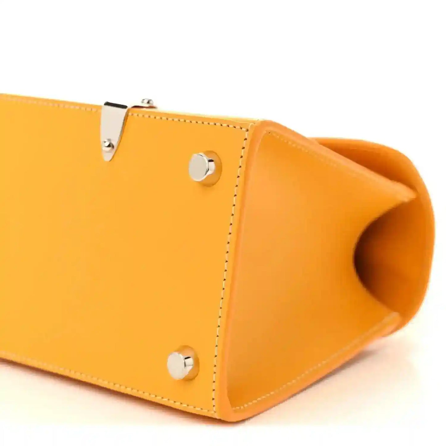 Yellow canvas handbag corner detail with silver snap hardware and open side opening.