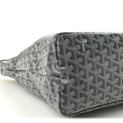 Grey canvas hobo bag close-up with zip edge, repeating pattern and logo patch