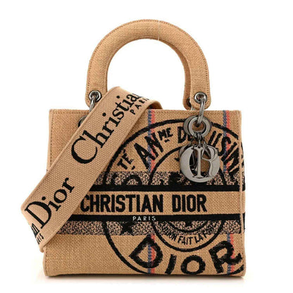 Medium jute canvas bag with embroidered Christian Dior motif, top handles, metal rings.