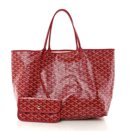 Red Goyardine canvas tote bag with front pocket detail and top handles.