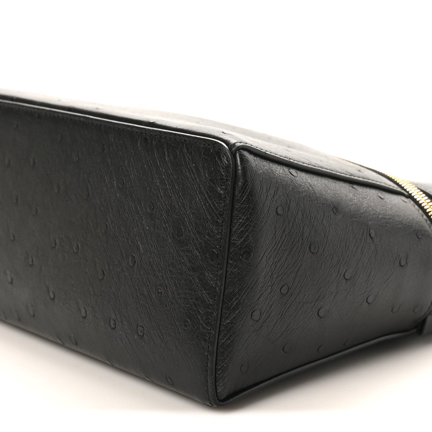 Black ostrich leather side panel with textured finish and curved top seam.