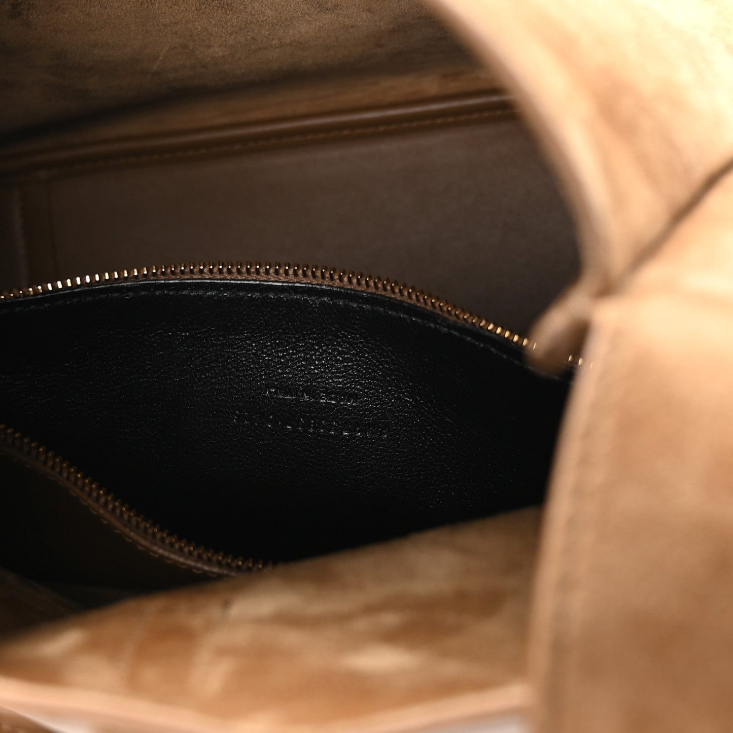 Suede hobo bag interior view with gold zipper track and dark lining
