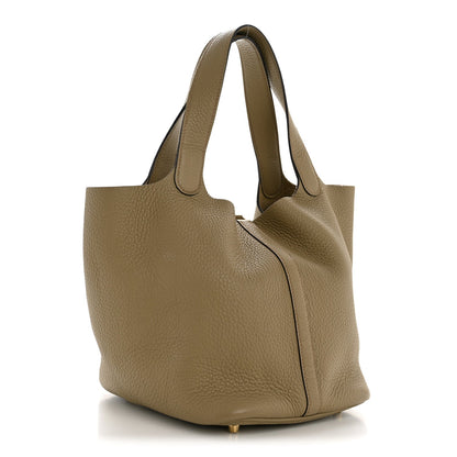 Beige leather slouchy tote with top handles and side lock detail