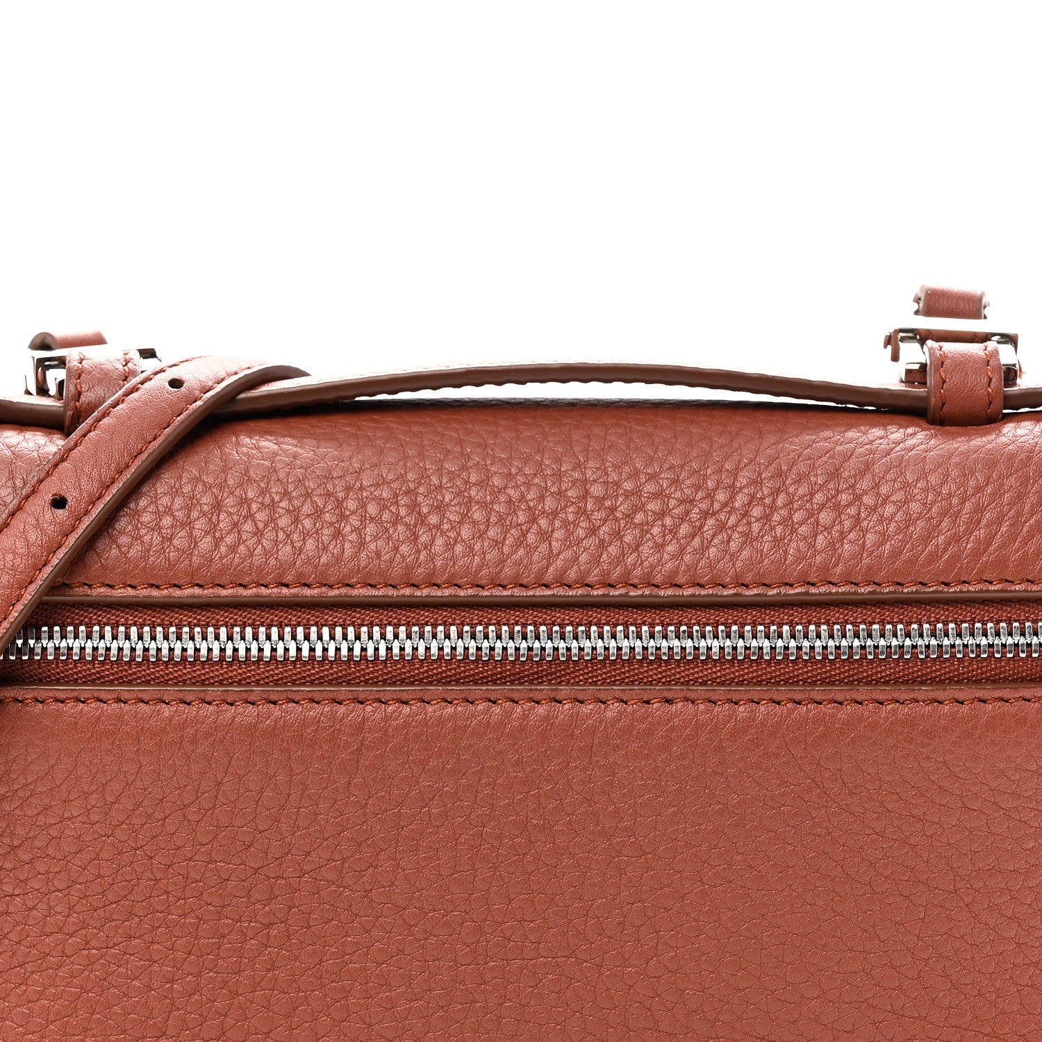 Top view of grained calfskin pouch with zip, leather handle loops, and buckles