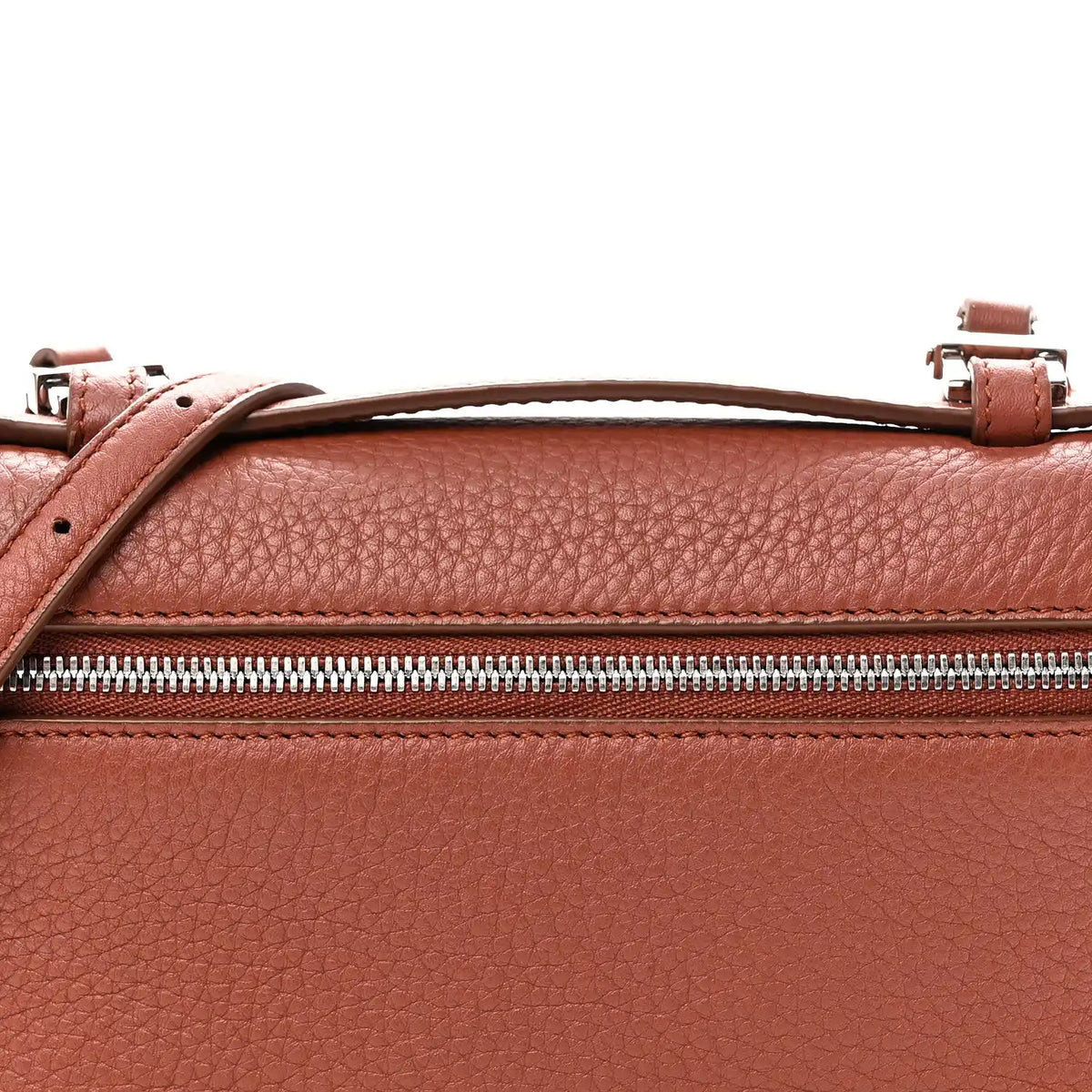 Top view of grained calfskin pouch with zip, leather handle loops, and buckles