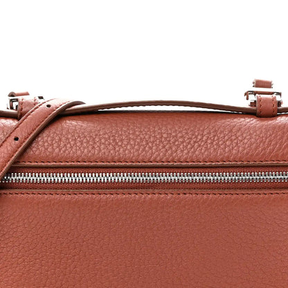 Top view of grained calfskin pouch with zip, leather handle loops, and buckles