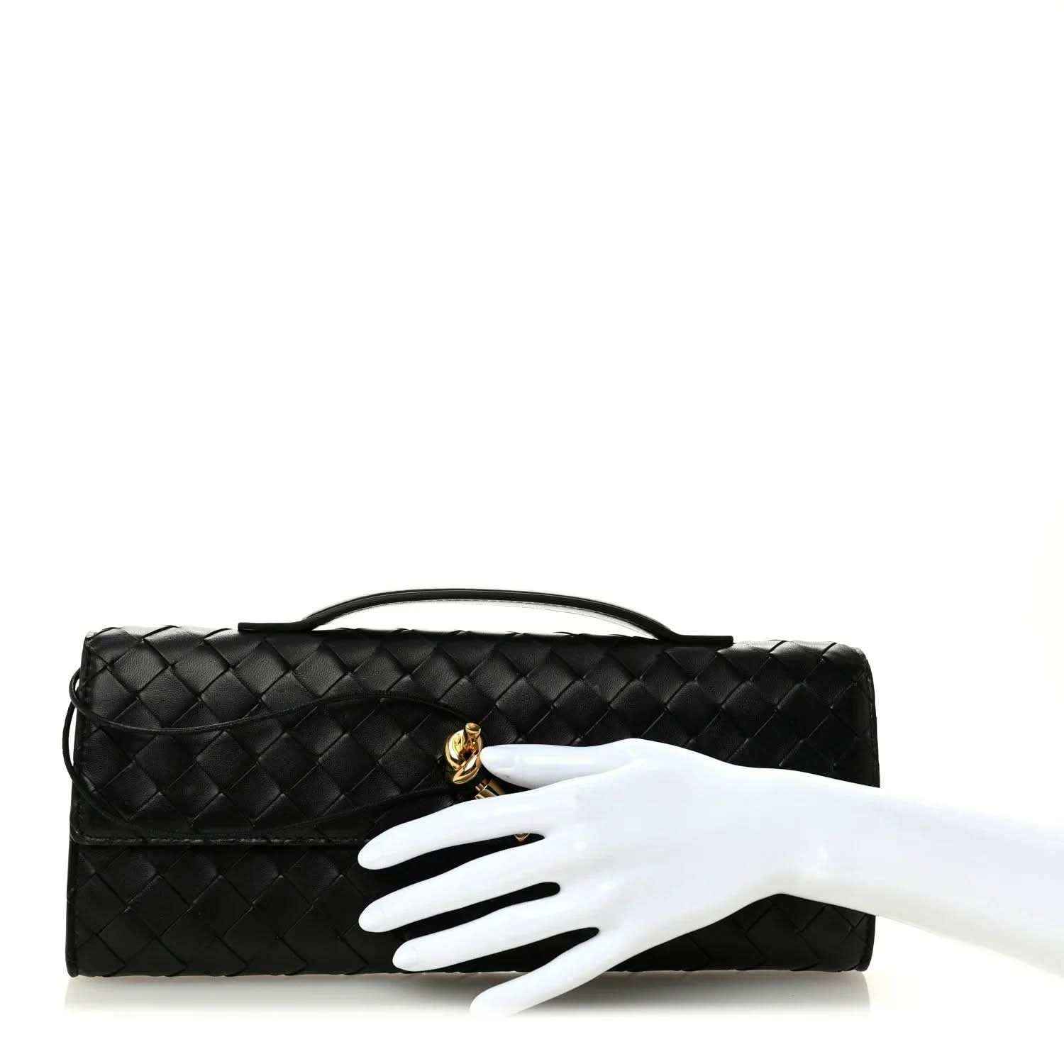 Black woven leather clutch with top handle and gold clasp detail
