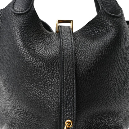 Black leather tote bag top with zipper pull and gold-tone hardware