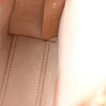 Pink beige leather panel and stitching inside micro handbag with embossed brand detail