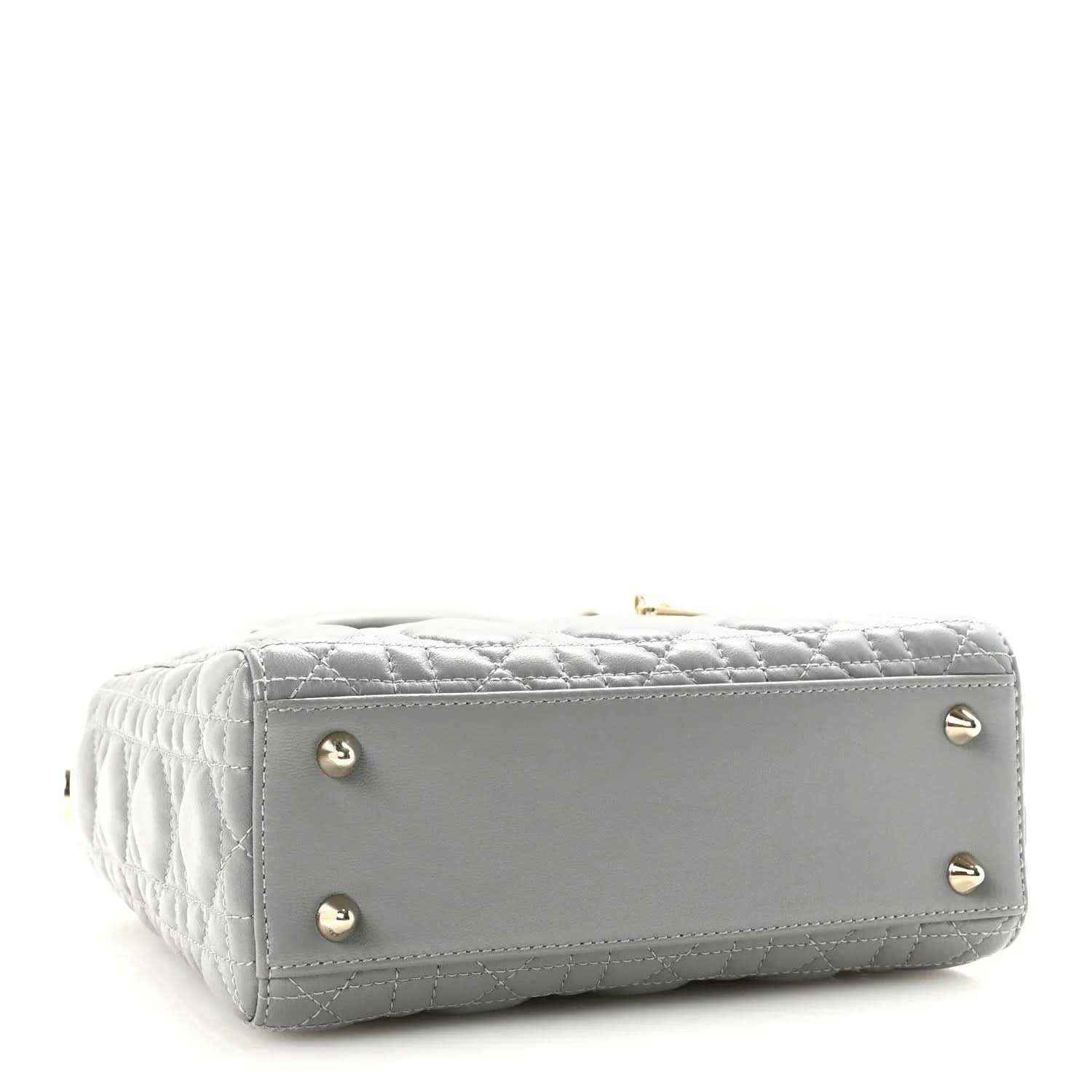 Grey quilted Lady Dior handbag with gold studs on the structured bottom