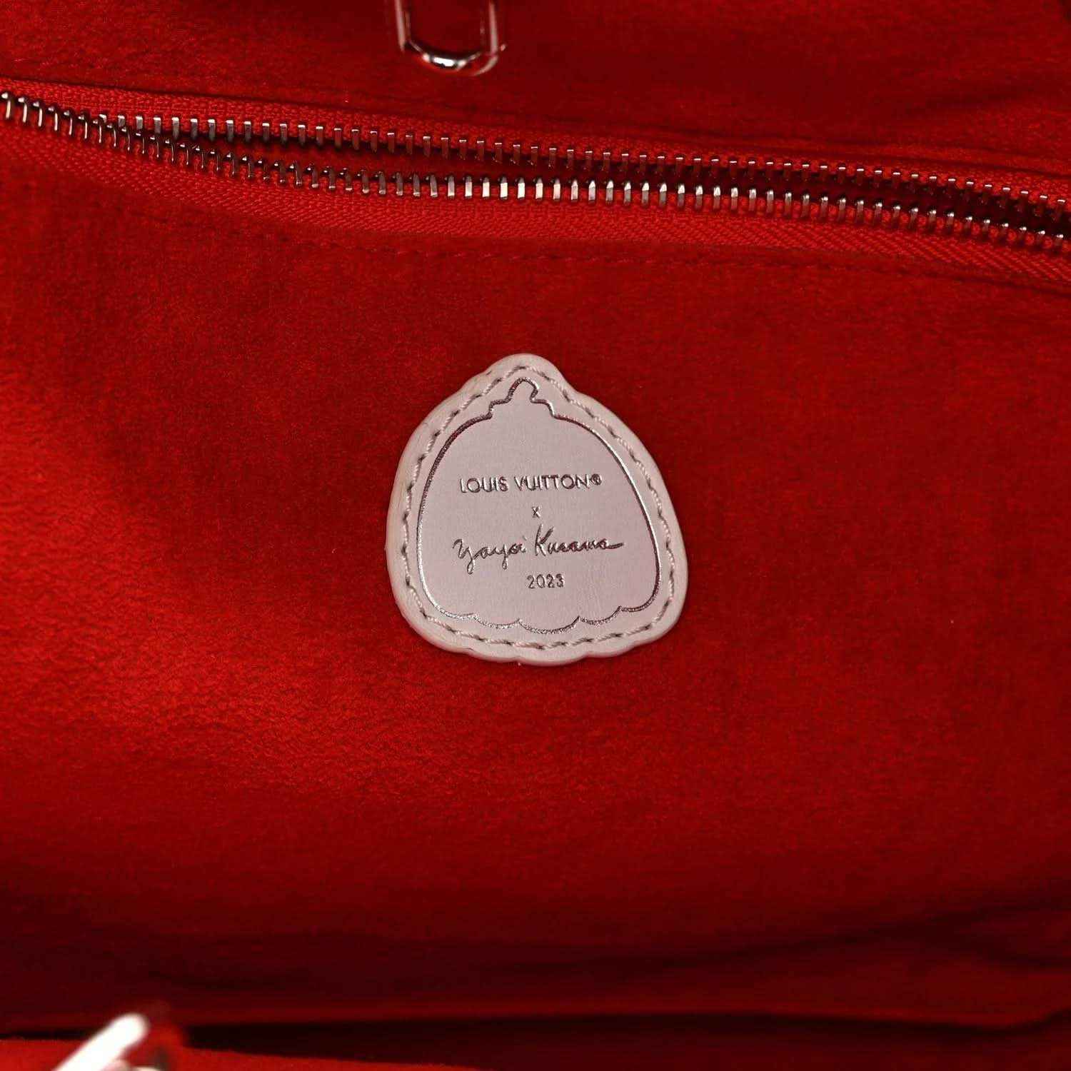 Red tote bag interior label with Louis Vuitton text on stitched leather patch