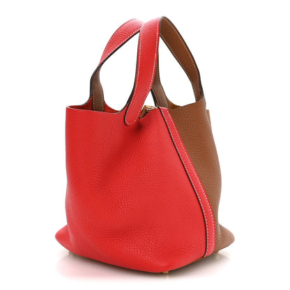 Two-tone leather tote bag with curved handles, red front and brown sides