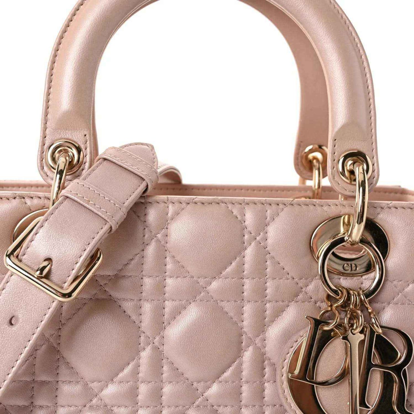 Light pink quilted handbag top with rings, gold hardware, and CD charm