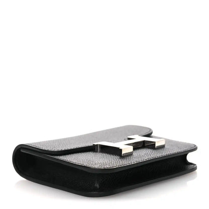 Black slim leather wallet open, showing interior card slots