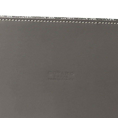 Grey leather handbag base with white stitching and subtle embossed maker text.