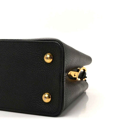 Louis Vuitton Capucines BB bag corner close-up with gold stud and strap attachment