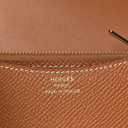 Constance slim wallet close-up showing zipper and embossed marks on tan leather