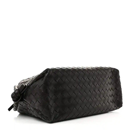 Black woven leather weekender bag with knotted tassel detail on the side