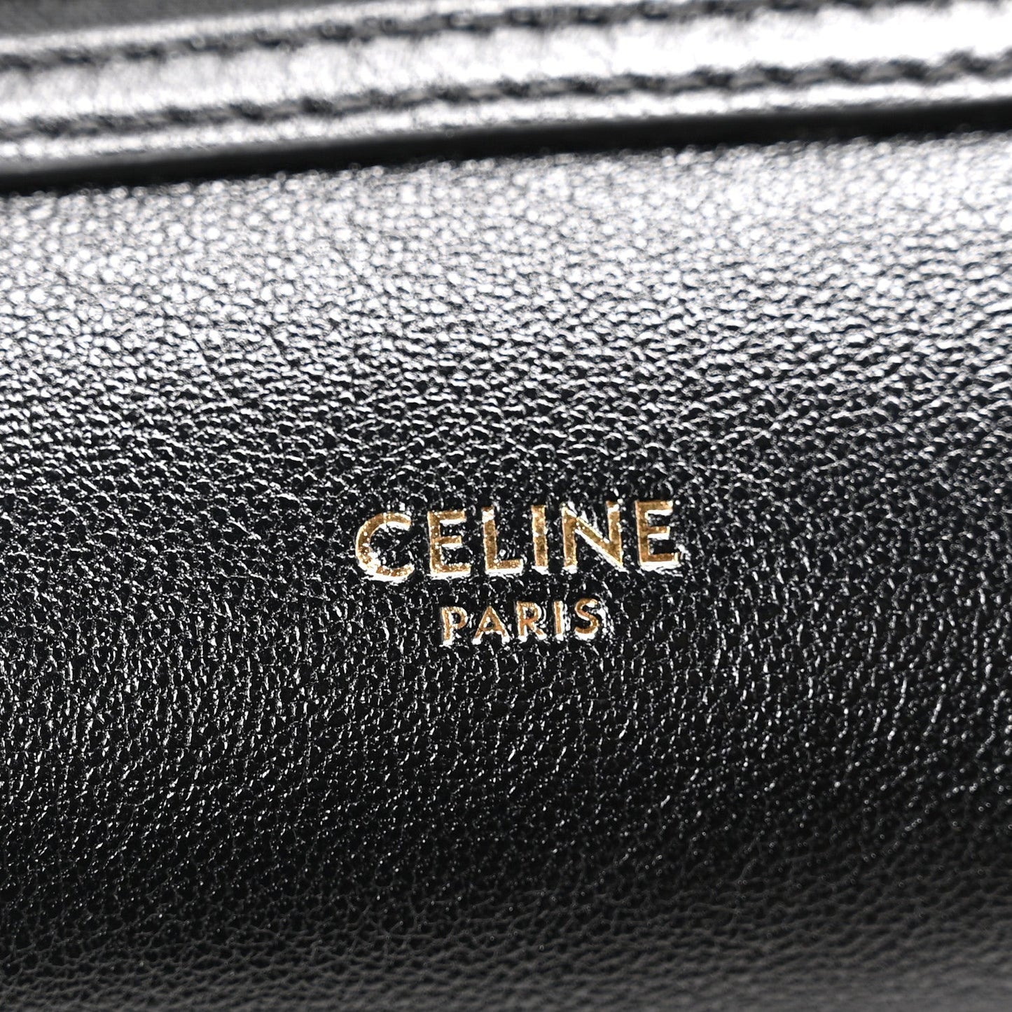 Celine black leather logo plaque reading “CELINE PARIS”