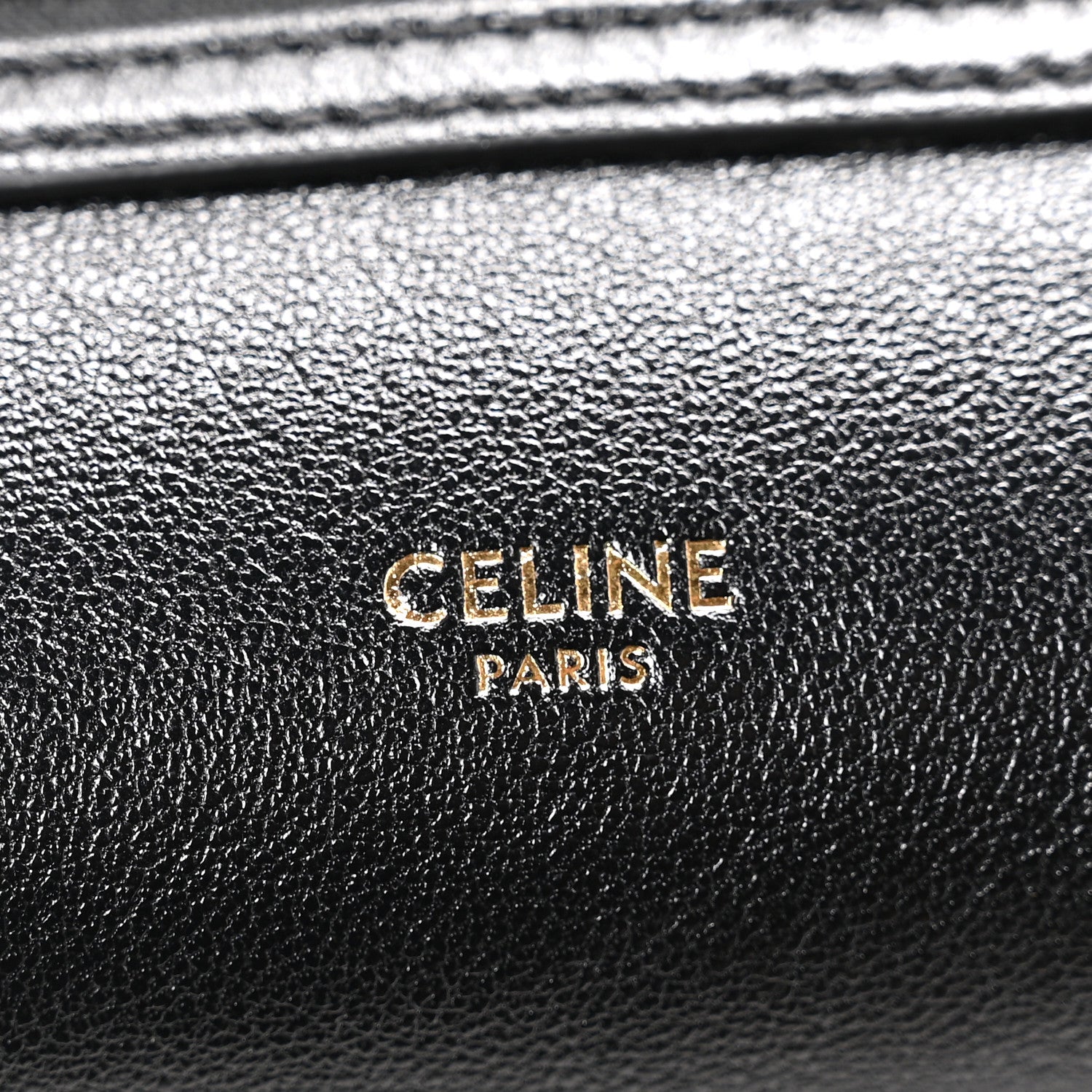 Celine black leather logo plaque reading “CELINE PARIS”
