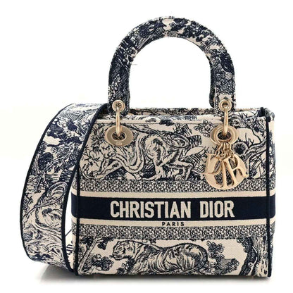 Blue toile de Jouy embroidered handbag with top handles, gold hardware, and Dior logo front.