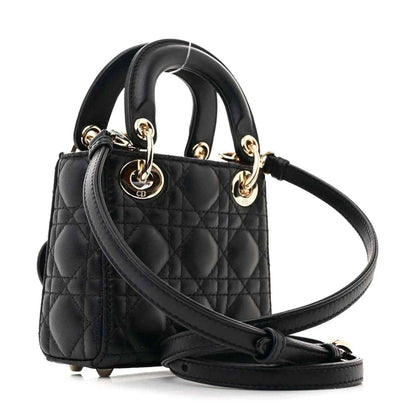Black quilted micro handbag with gold-tone chain handle and crossbody strap