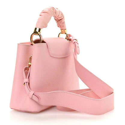 Bubble gum pink leather Capucines BB bag with crossbody strap and gold handle hardware