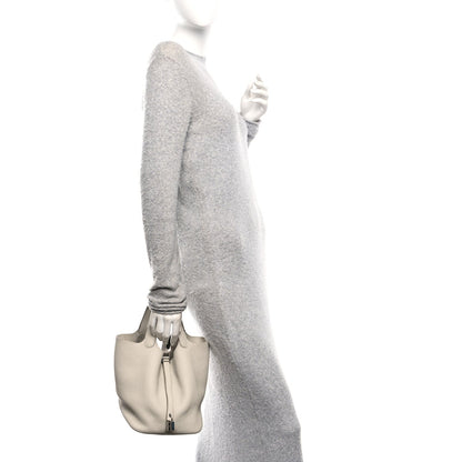 Ivory leather tote bag with short handles, carried in hand