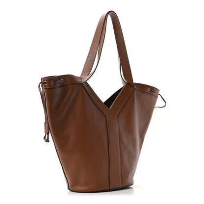 Tan-brown calfskin Y drawstring tote bag with wide top handles and side tie cords