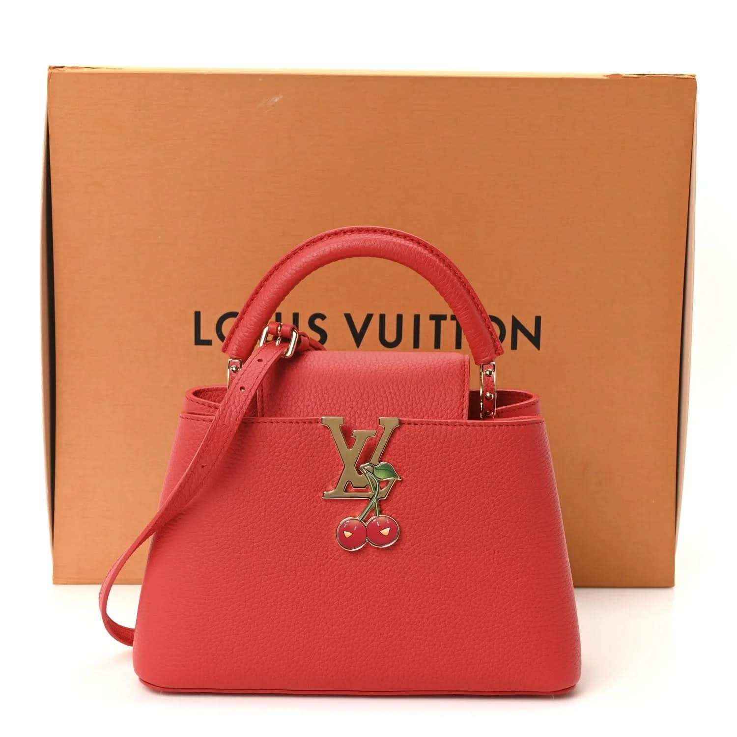 Red leather mini handbag with LV cherry charm, top handles, and included dust bag.