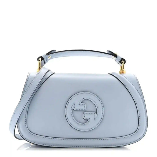 Light blue Gucci calfskin top-handle bag with front logo plaque and gold hardware
