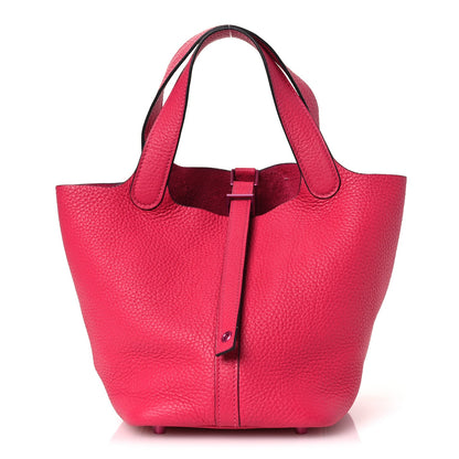 Rose pink textured calfskin bucket tote with top handle and front strap buckle