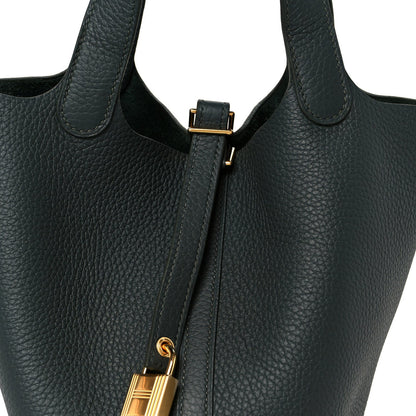 Dark green leather tote with top tab and gold-tone lock hardware at center