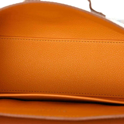 Tan leather flap with stitched seam details, smooth pebbled texture