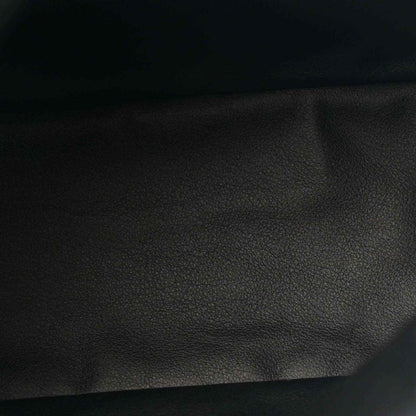 Black leather panel close-up with pebbled texture from a reversible tote bag