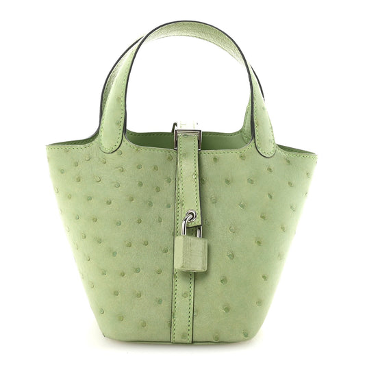 Green mini handbag with top handles, central lock, and ostrich texture pattern