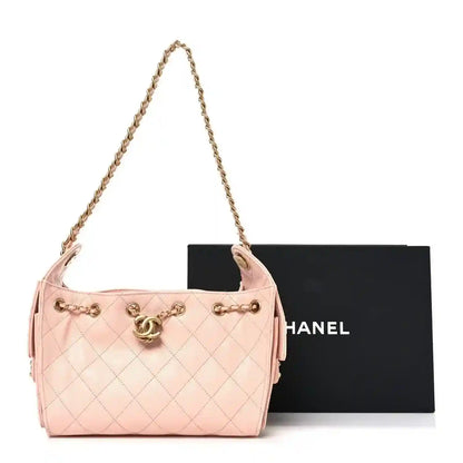 Chanel quilted mini handbag, light pink caviar-style leather, chain strap and flap clasp