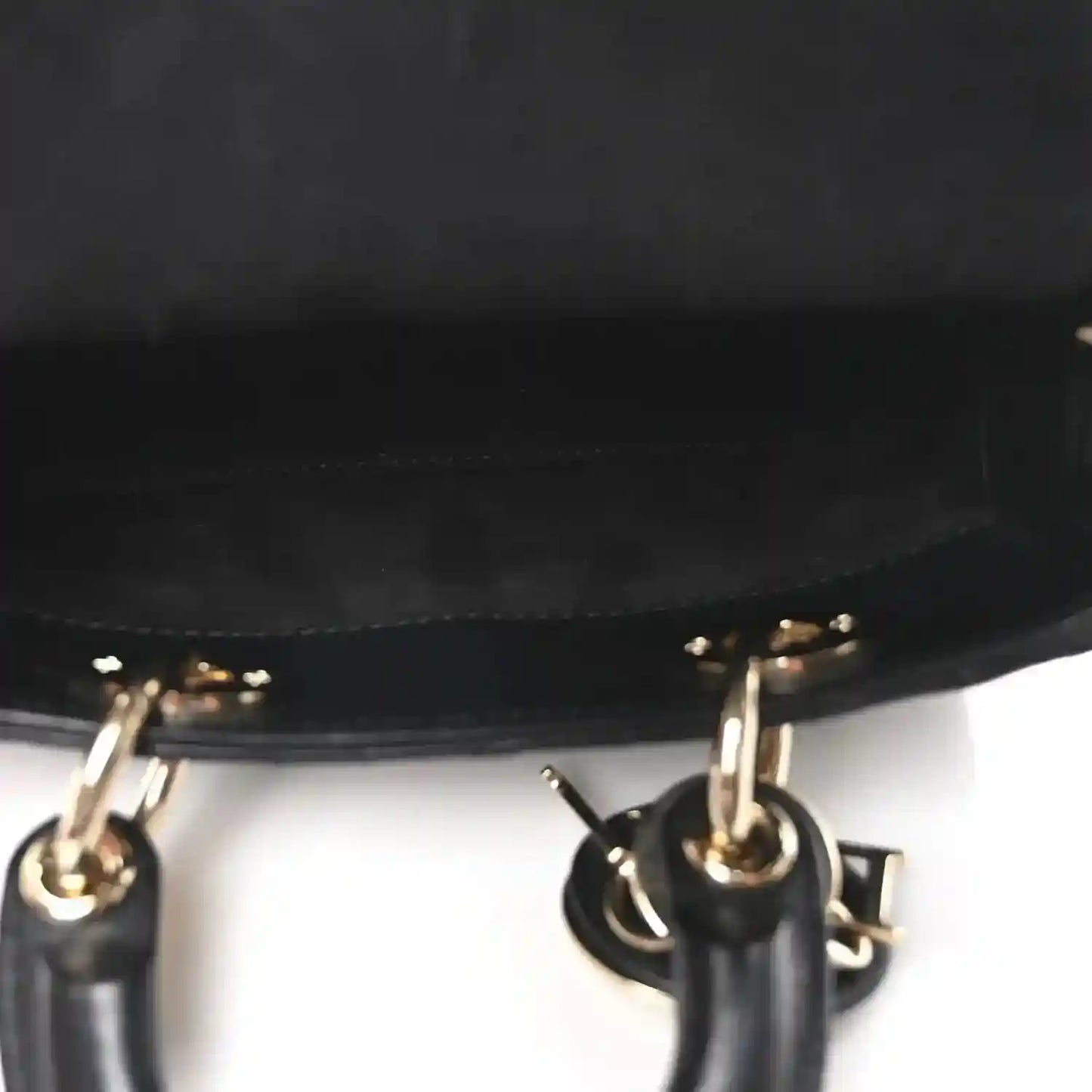 Black handbag chain strap with gold-tone rings and hardware close-up